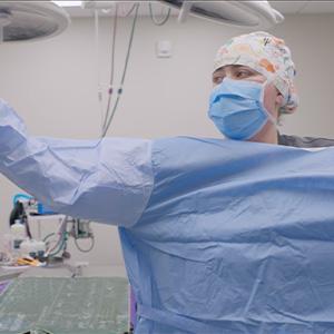 thumbnail - putting on a sterile gown in surgery